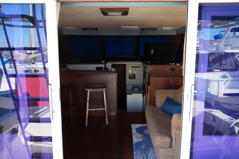 Slide: The Image of Interior view of 1987 Hatteras 36 Convertible yacht with cozy seating and nautical decor. - 20