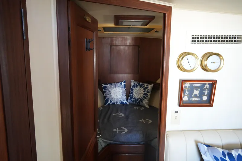 Slide: The Image of Cozy cabin interior of 1987 Hatteras 36 Convertible yacht with nautical decor. - 21