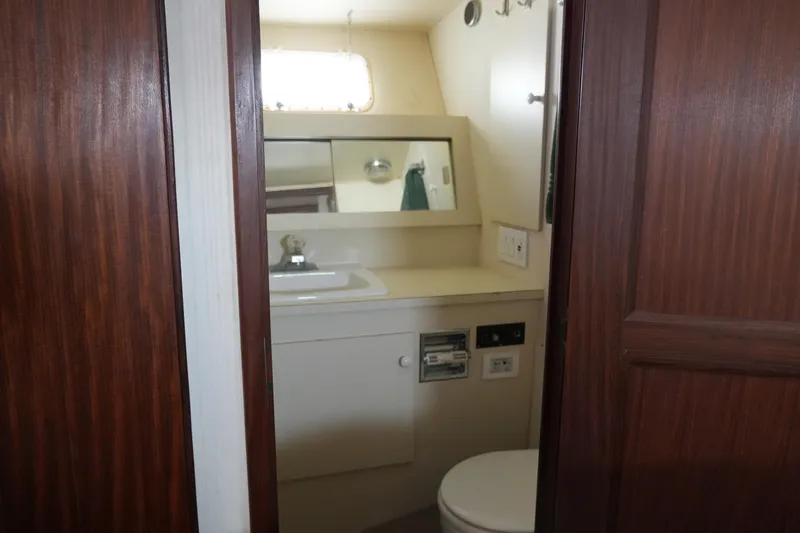 Slide: The Image of Bathroom interior of 1987 Hatteras 36 Convertible yacht, featuring sink and mirror. - 23