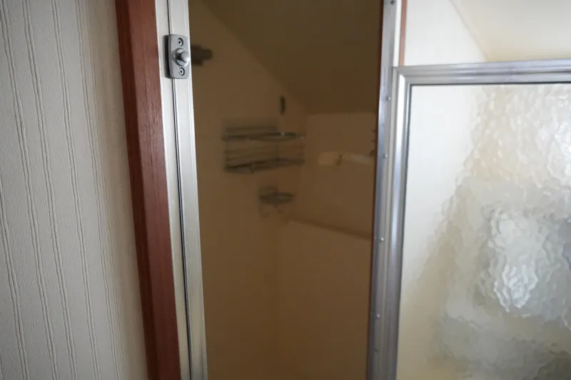 Slide: The Image of Shower area inside 1987 Hatteras 36 Convertible boat with frosted glass door. - 24