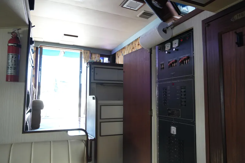 Slide: The Image of Interior of 1987 Hatteras 36 Convertible yacht showing control panel and seating area. - 28