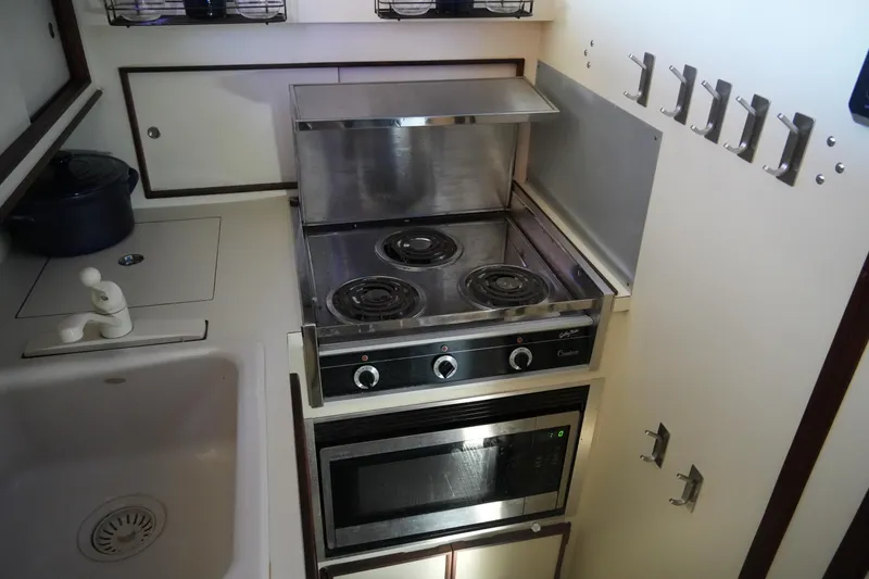 Slide: The Image of Compact kitchen in 1987 Hatteras 36 Convertible yacht with stove and microwave. - 31