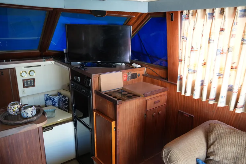Slide: The Image of Interior of 1987 Hatteras 36 Convertible yacht with cozy seating and modern amenities. - 33