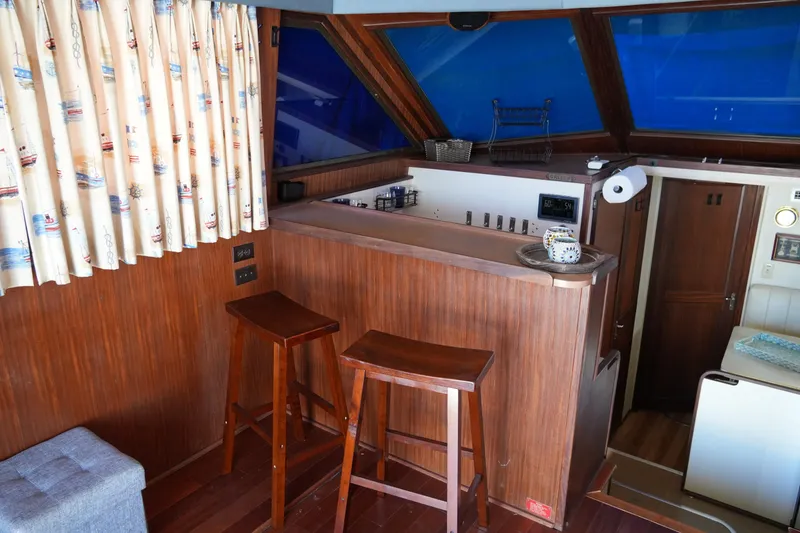 Slide: The Image of Interior of 1987 Hatteras 36 Convertible yacht with wooden bar and stools. - 34