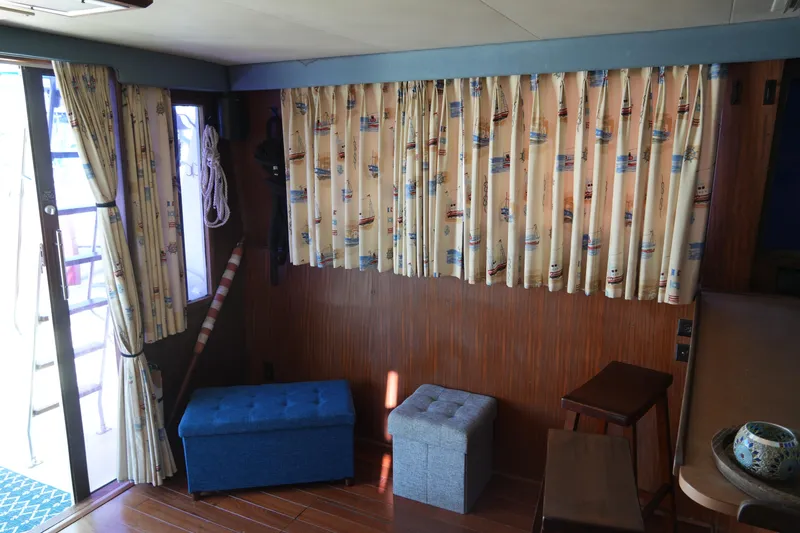 Slide: The Image of Interior of 1987 Hatteras 36 Convertible with nautical-themed curtains and seating. - 36