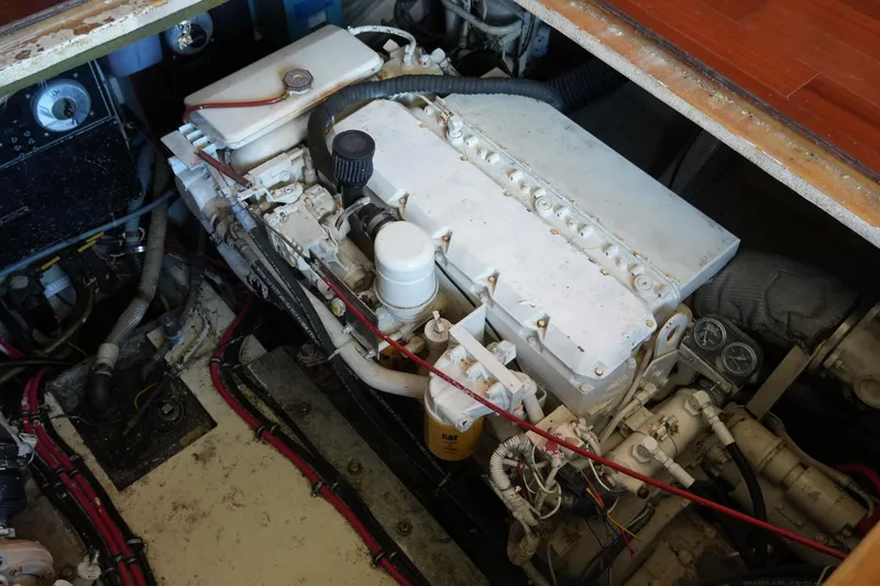 Slide: The Image of Engine compartment of a 1987 Hatteras 36 Convertible boat, showcasing mechanical components. - 38