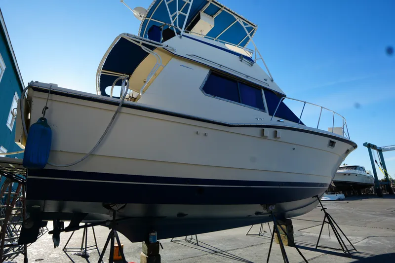 Slide: The Image of 1987 Hatteras 36 yacht on dry dock under clear blue sky. - 41