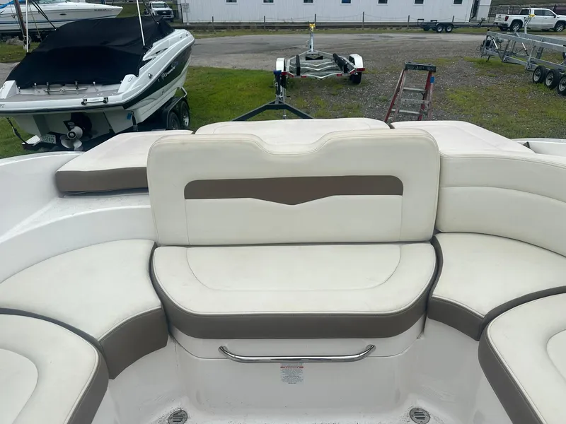 Slide: The Image of 2013 Chaparral 246 SSi boat interior with white and beige seating. - 11