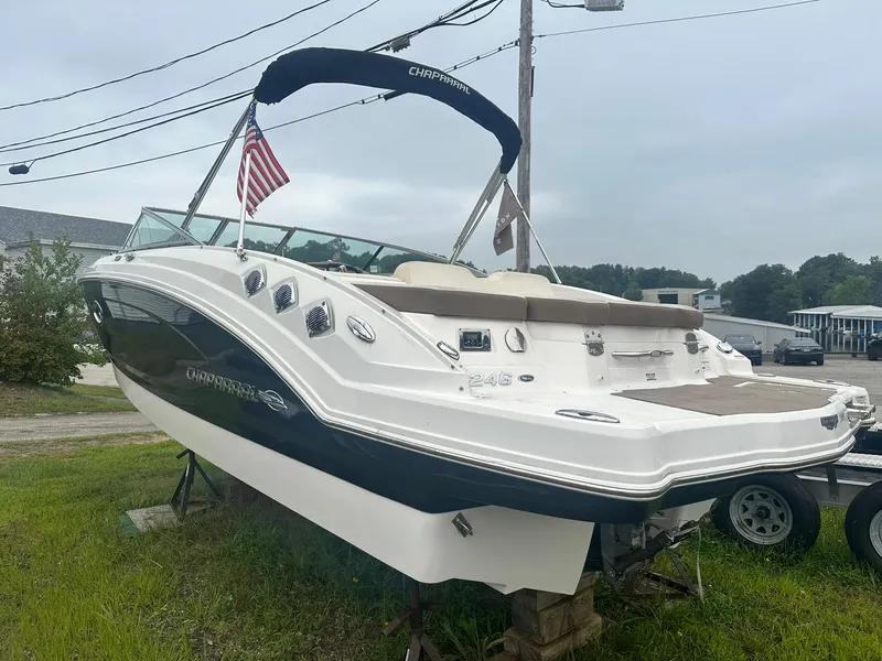 Slide: The Image of 2013 Chaparral 246 SSi boat on display, featuring sleek design and American flag. - 2