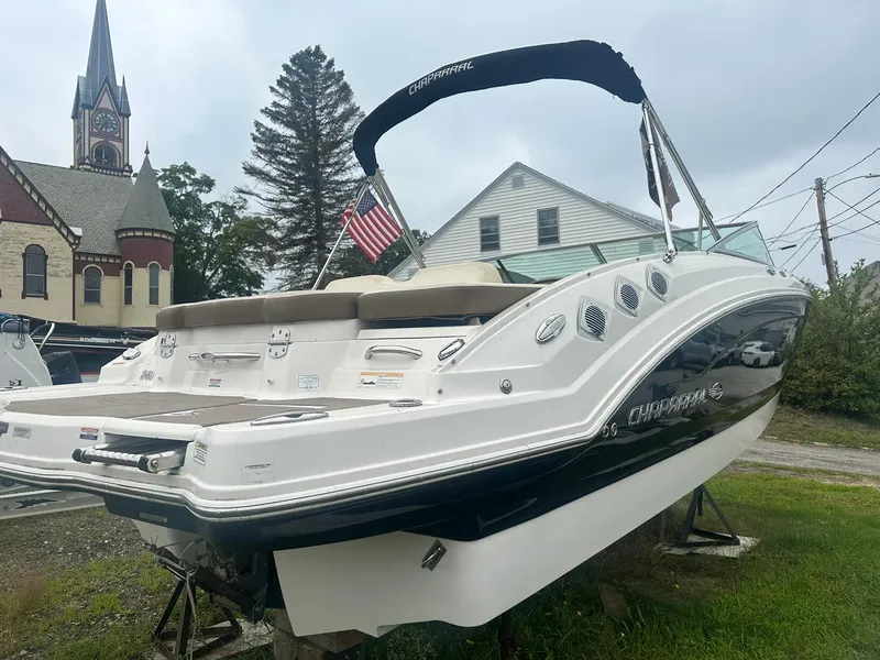 Slide: The Image of 2013 Chaparral 246 SSi boat on display, with American flag, near historic buildings. - 3