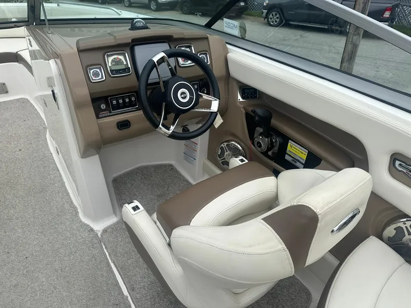 Slide: The Image of Interior of 2013 Chaparral 246 SSi boat, featuring steering wheel and dashboard controls. - 5