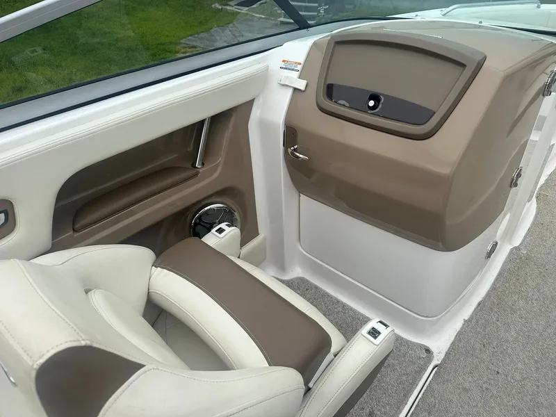 Slide: The Image of 2013 Chaparral 246 SSi boat interior with beige and brown seating and dashboard. - 6