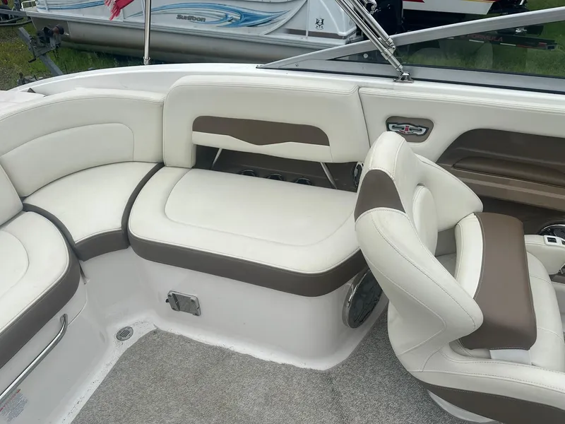 Slide: The Image of 2013 Chaparral 246 SSi boat interior with white and brown seating. - 9