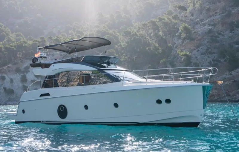 Slide: The Image of 2017 Beneteau Monte Carlo 5 MC5 yacht on turquoise water, scenic background. - 0