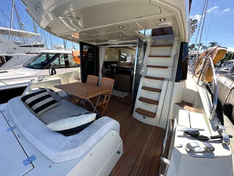 Slide: The Image of 2017 Beneteau Monte Carlo 5 MC5 yacht interior with seating, table, and stairs. - 11