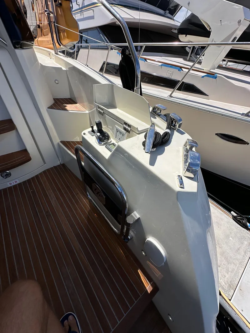 Slide: The Image of 2017 Beneteau Monte Carlo 5 MC5 yacht helm with wooden deck and controls. - 12