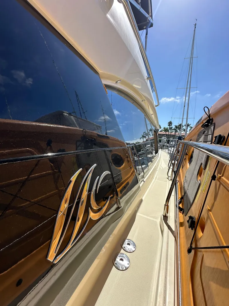 Slide: The Image of 2017 Beneteau Monte Carlo 5 MC5 yacht, sleek design, docked under clear blue sky. - 15