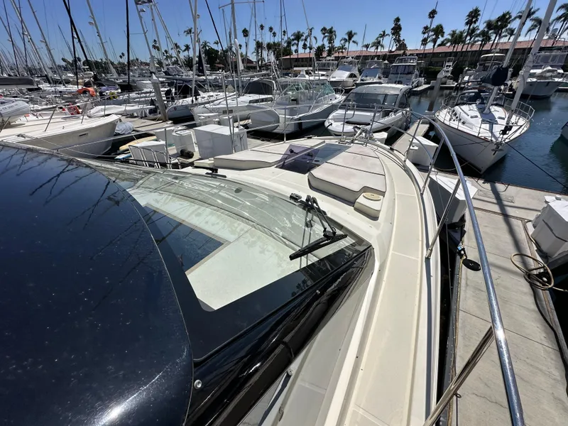 Slide: The Image of 2017 Beneteau Monte Carlo 5 MC5 yacht docked at marina, surrounded by sailboats. - 17
