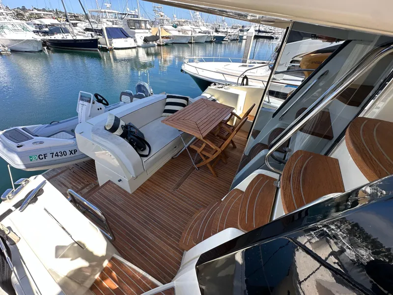 Slide: The Image of 2017 Beneteau Monte Carlo 5 MC5 yacht with elegant deck seating and wooden table. - 32