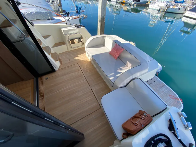 Slide: The Image of 2017 Beneteau Monte Carlo 5 MC5 yacht deck with seating area and marina view. - 33