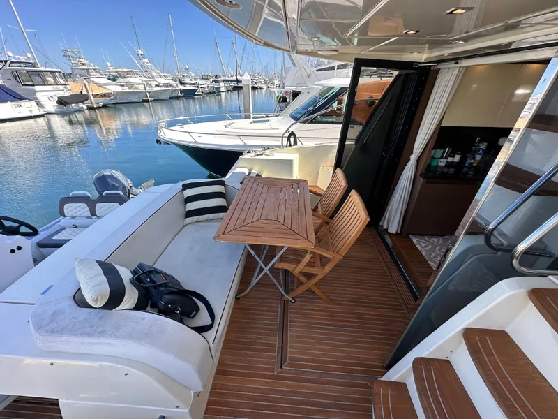 Slide: The Image of 2017 Beneteau Monte Carlo 5 MC5 yacht with elegant deck seating and marina view. - 34