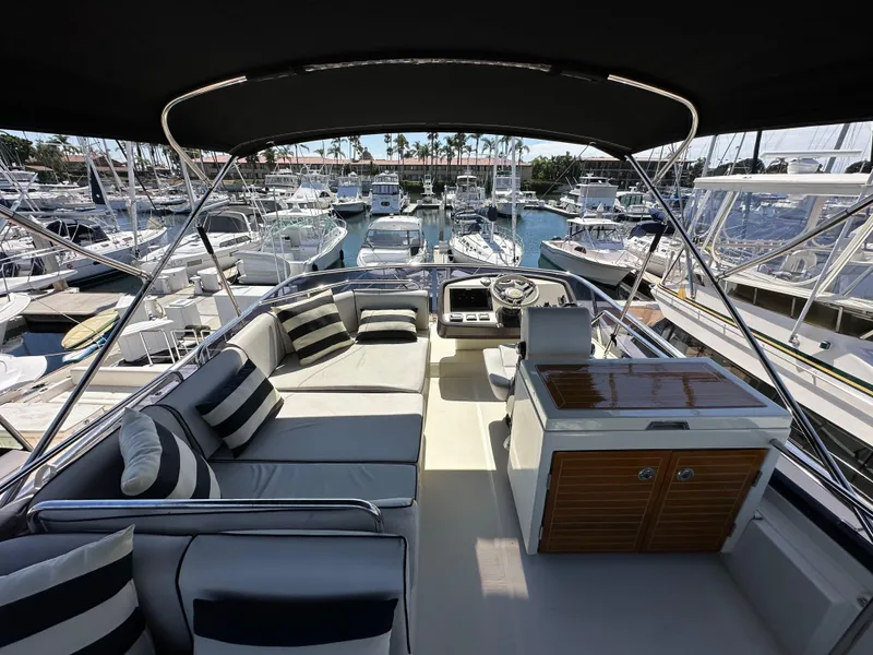 Slide: The Image of 2017 Beneteau Monte Carlo 5 MC5 yacht interior with seating and helm, docked at marina. - 46