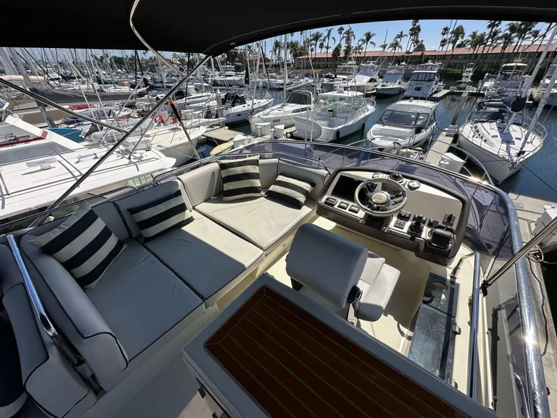 Slide: The Image of 2017 Beneteau Monte Carlo 5 MC5 yacht interior with helm and seating area in marina. - 48