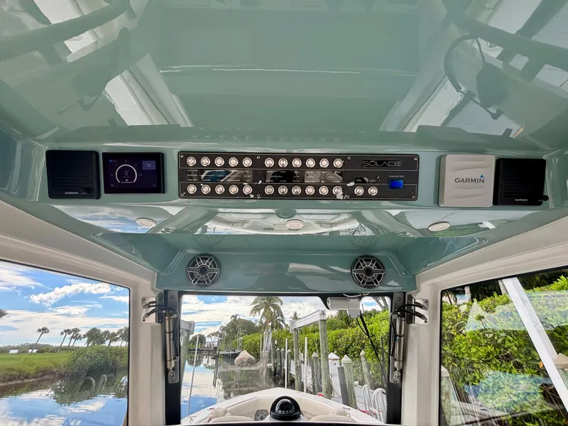 Slide: The Image of 2020 Solace 345 CC boat dashboard with control panel and Garmin system. - 13