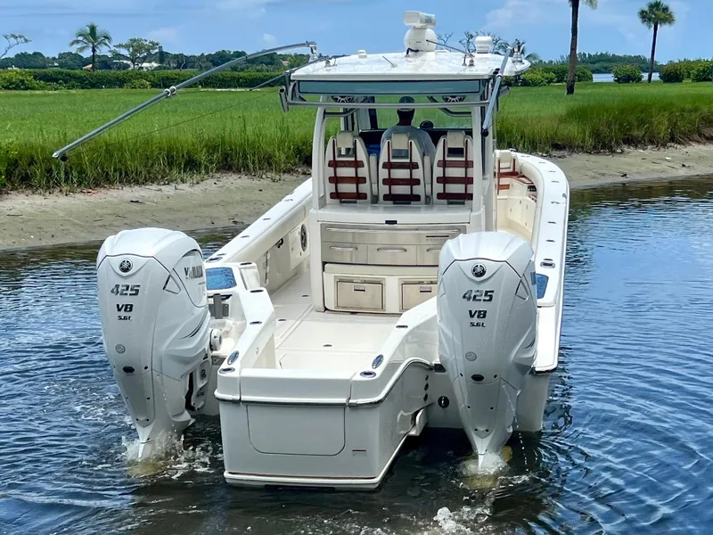 Slide: The Image of 2020 Solace 345 CC boat with twin 425 V8 engines in a scenic waterway. - 2