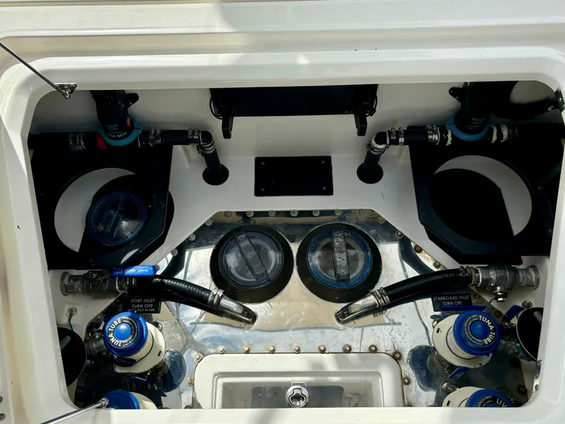 Slide: The Image of Engine compartment of a 2020 Solace 345 CC boat, showcasing mechanical components and hoses. - 21