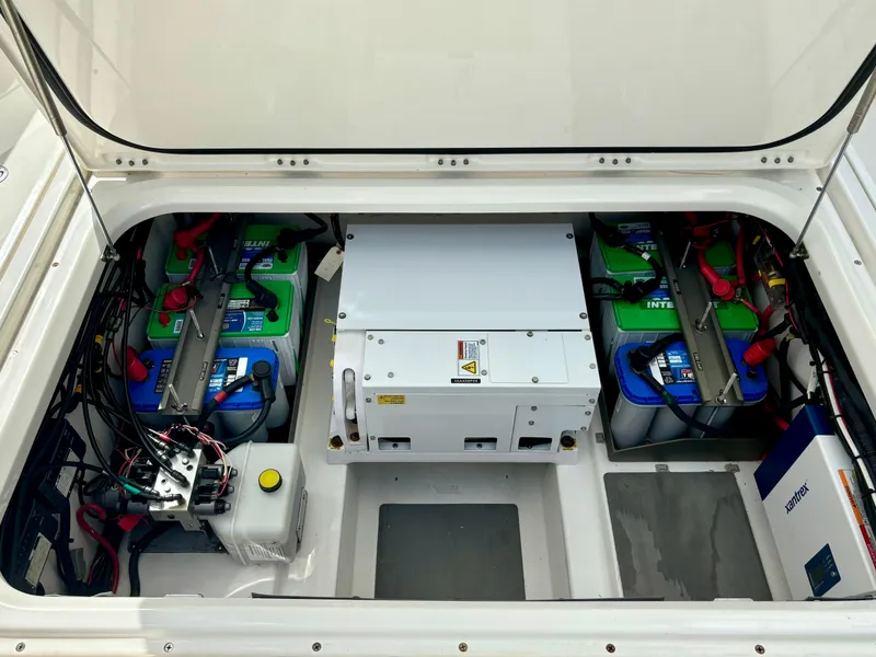 Slide: The Image of 2020 Solace 345 CC boat battery compartment with multiple batteries and wiring. - 22