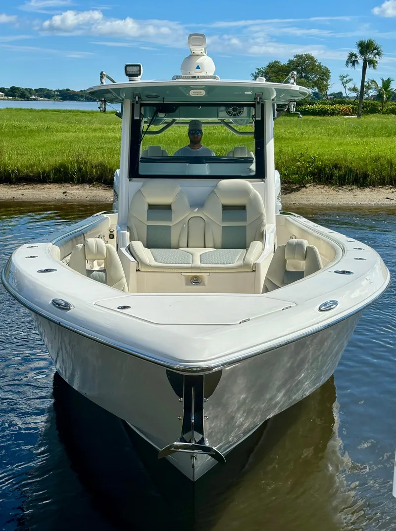 Slide: The Image of 2020 Solace 345 CC boat on calm water with scenic background. - 3