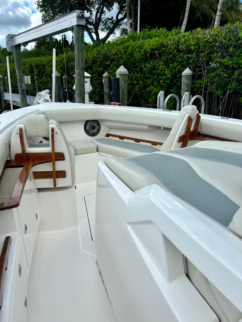 Slide: The Image of 2020 Solace 345 CC boat interior with white seating and wooden accents. - 7