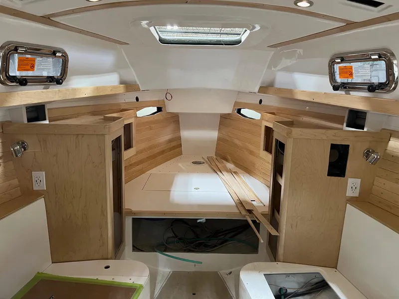 Slide: The Image of Interior of 2025 Tartan 335 sailboat, featuring modern wood finish and ample natural light. - 5