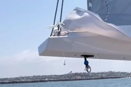 Slide: The Image of Close-up of a Tartan 335 sailboat's sail and rigging, 2026 model, on a calm sea. - 7