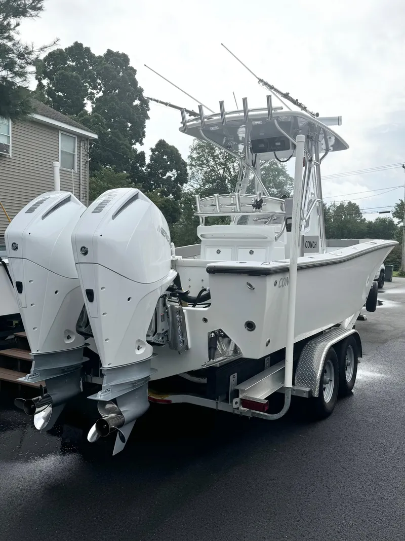 Slide: The Image of 2022 Conch 27 CC boat with dual engines on a trailer. - 2