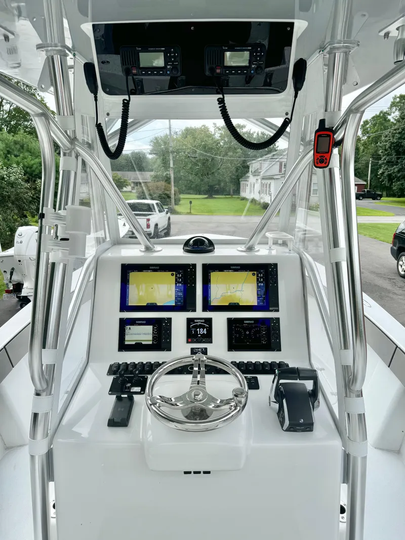 Slide: The Image of 2022 Conch 27 CC boat dashboard with advanced navigation and control systems. - 4