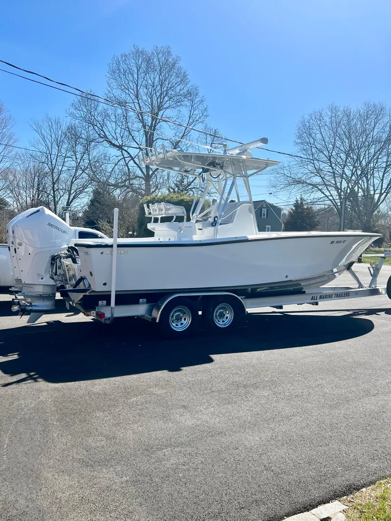 Slide: The Image of 2022 Conch 27 CC boat on trailer, parked outdoors. - 5
