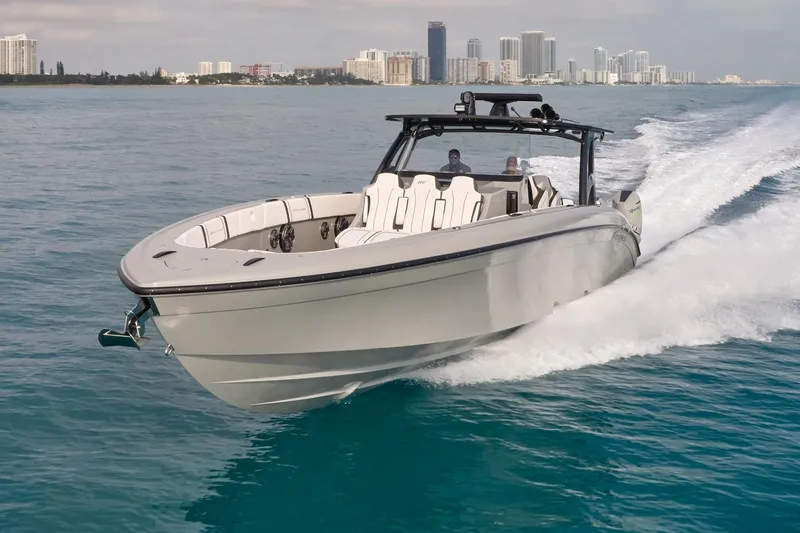 Slide: The Image of 2021 Midnight Express 43 Open boat cruising on blue water near city skyline. - 12