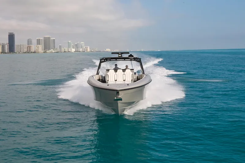 Slide: The Image of 2021 Midnight Express 43 Open boat cruising on blue ocean near city skyline. - 15