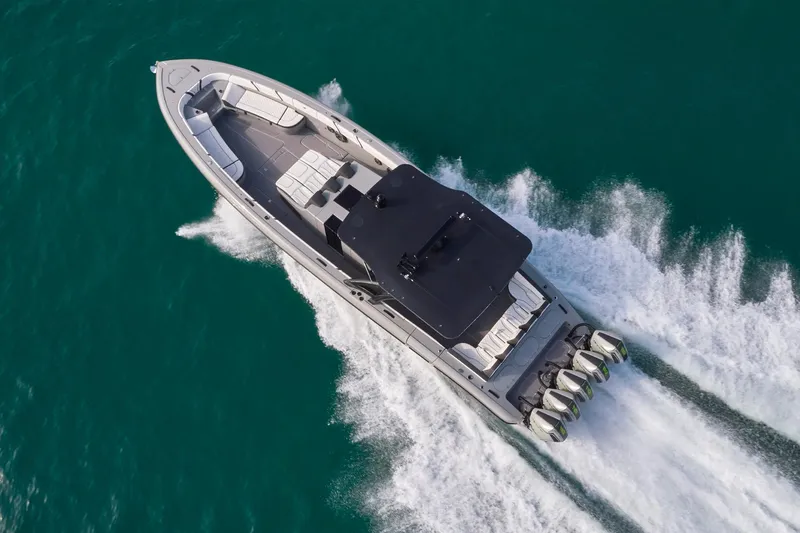 Slide: The Image of Aerial view of 2021 Midnight Express 43 Open boat speeding on turquoise water. - 16