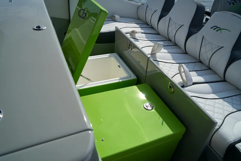 Slide: The Image of Midnight Express 43 Open 2021 boat interior with green storage compartment and cushioned seating. - 6