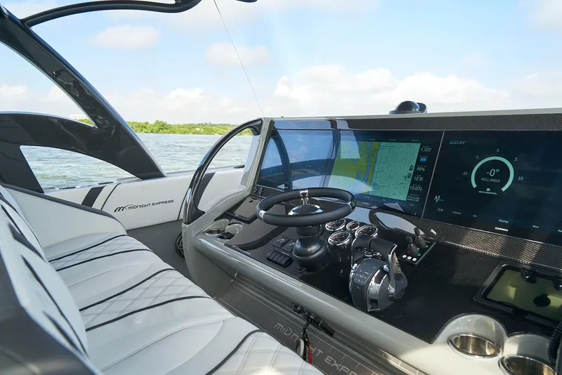 Slide: The Image of 2021 Midnight Express 43 Open boat cockpit with modern navigation system. - 8