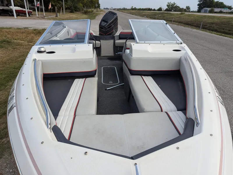 Slide: The Image of 1990 Bayliner 180 Capri boat interior with open seating and windshield. - 12