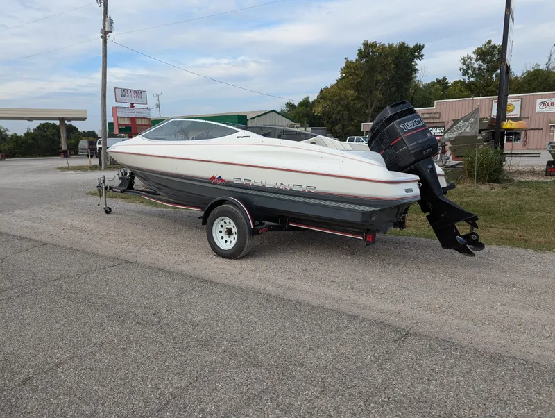 Slide: The Image of 1990 Bayliner 180 Capri boat on trailer, parked outdoors. - 3