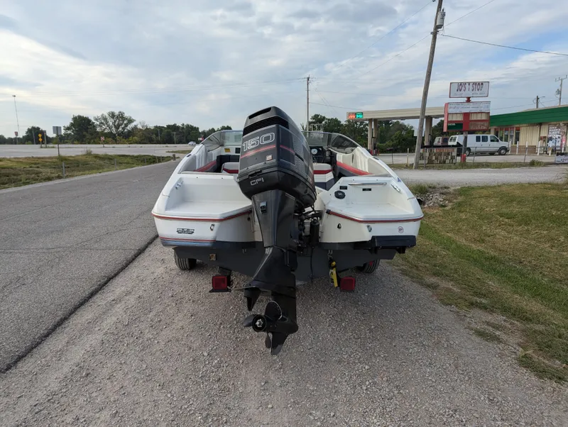 Slide: The Image of 1990 Bayliner 180 Capri boat with outboard motor on roadside. - 5