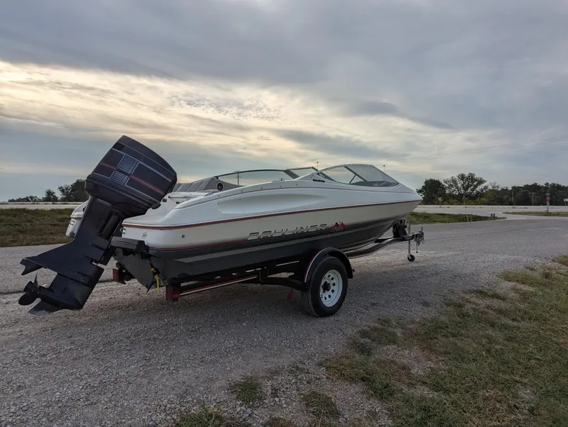 Slide: The Image of 1990 Bayliner 180 Capri boat on trailer under cloudy sky. - 7