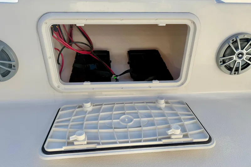 Slide: The Image of 2025 Carolina Skiff 21 LS boat battery compartment with wiring and speakers. - 11