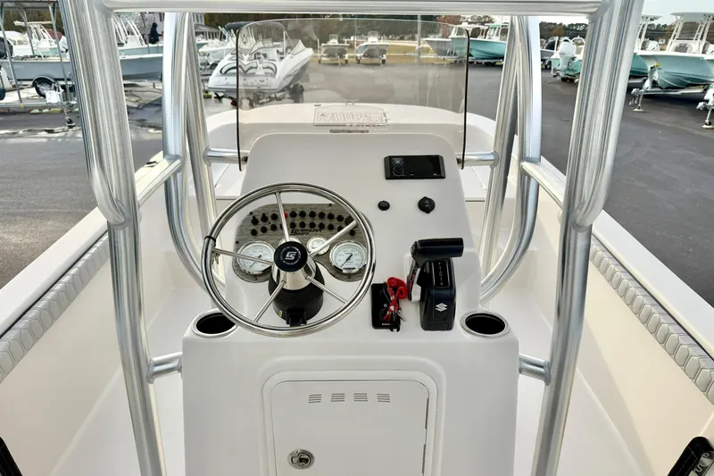 Slide: The Image of 2025 Carolina Skiff 21 LS boat console with steering wheel and controls. - 26
