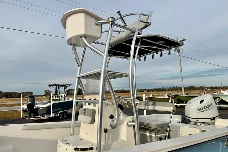 Slide: The Image of 2025 Carolina Skiff 21 LS boat with Suzuki outboard motor and T-top structure. - 33